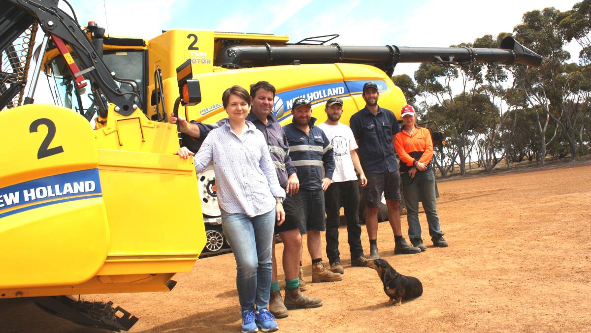 Lisa (left) and Kirk Jeitz and Milo the dog are ready for harvest with a mini United nations team of workers, from left, lead header driver Hayden Peirce, Esperance, drivers Quinn Johnson, New Zealand and Quentin Labtani, Belgium and chaser bin driver Natalie Dufour, Belgium. The mechanic, not in the picture, is Kyle Hildebrand, Canada. 