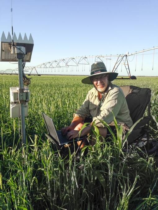 Senior development officer Chris Ham downloading data from a soil moisture probe on a commercial pivot in the Kimberley.