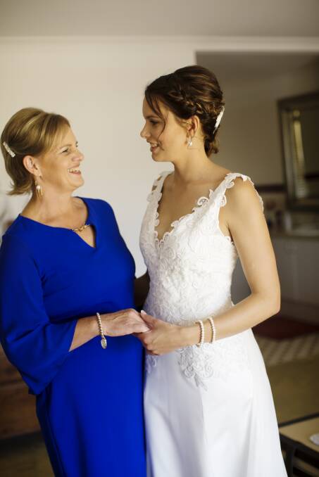 A special mother-daughter moment captured between Kaye Teede (left) and Debra on her wedding day last year. Kaye made Debra's bridal gown.