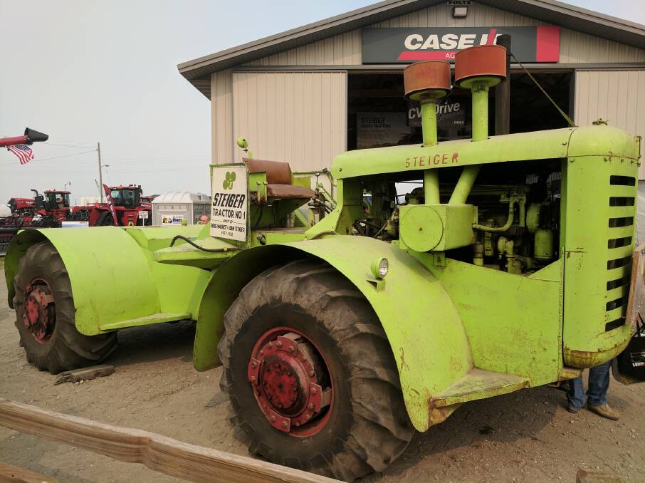A piece of history. The original Steiger tractor pictured outside the Steiger factory in Fargo, North Dakota. The Case IH logo on the shed tells you this photo was taken after 1986. Torque couldn't find out who the legs belonged to (bottom of the radiator).