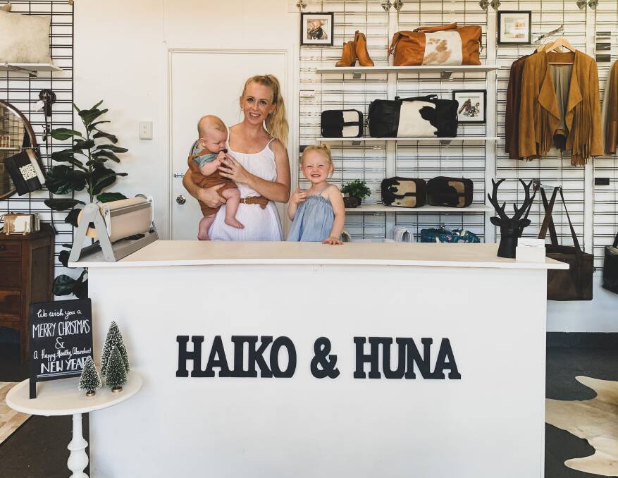 Haiko & Huna owner Annie Berg, with her two children Waylon James, 4 months, and Bonnie Mae, 2.5-years-old, standing inside their Ravenshoe store. 