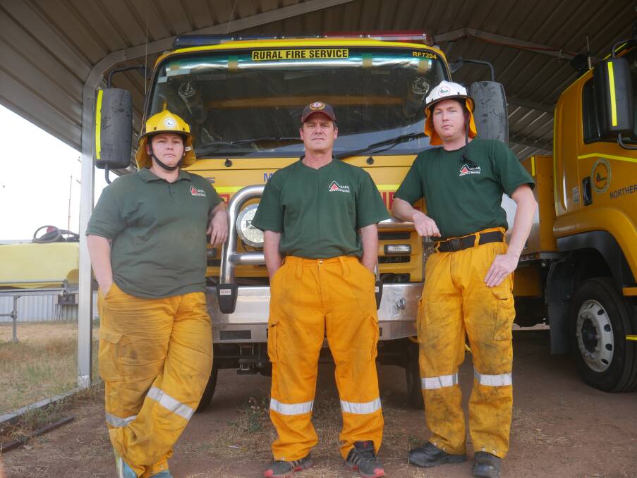 HEROES: Kim Smith, Gavin Donnelly and Kris Smith back at the Mount Isa fire brigade station. Photo: Aidan Green. 