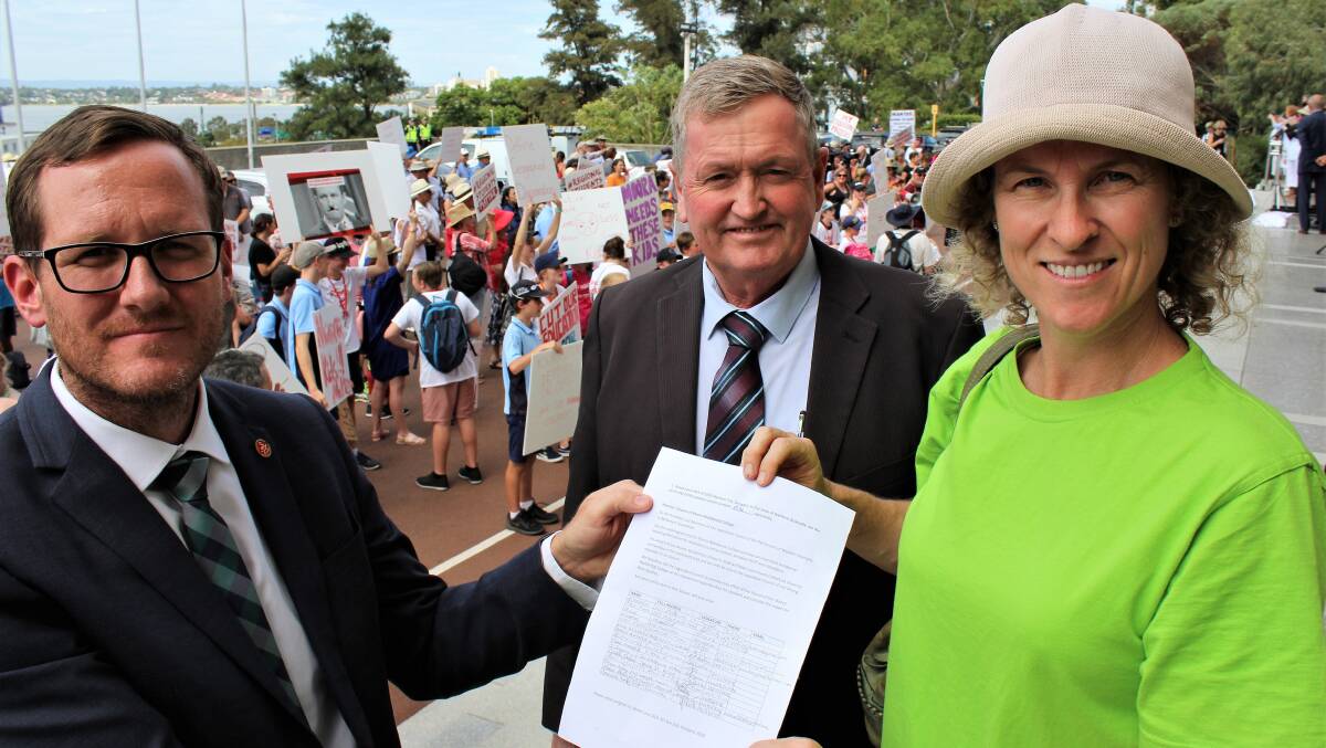 Martin Aldridge and Shane Love are presented the petition by Moora resident Melissa Cameron at Parliament.