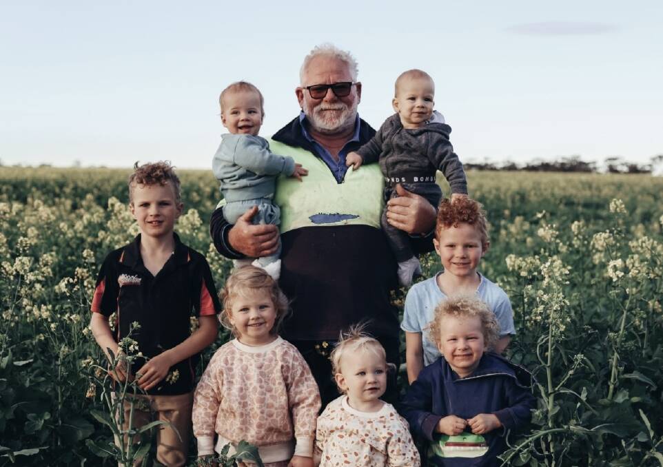 Ross Della Bosca (centre) checking the crop with his grandchildren, holding Lachlan (left) and Vinnie (right), with Charlie (bottom left), Indie, Coah, Nash and Archie.
