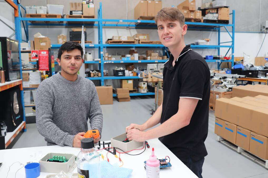 Liam Cannon (right) and Abdul Mujeep working on components at the Bibra Lake factory.
