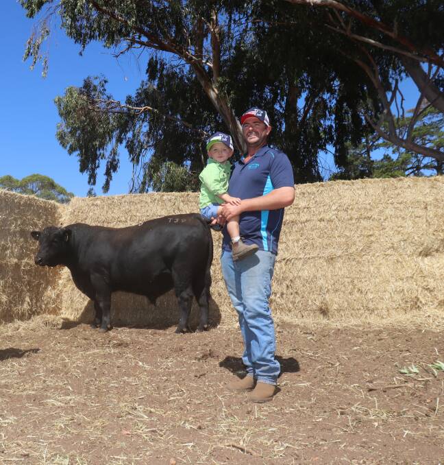 The $12,500 second top-priced bull, Carenda Thor T39, which was bought via AuctionsPlus by Wes Graham, WJ & FJ Graham, Esperance. With the bull is Carenda stud co-principal Matt Kitchen holding his son Jack.
