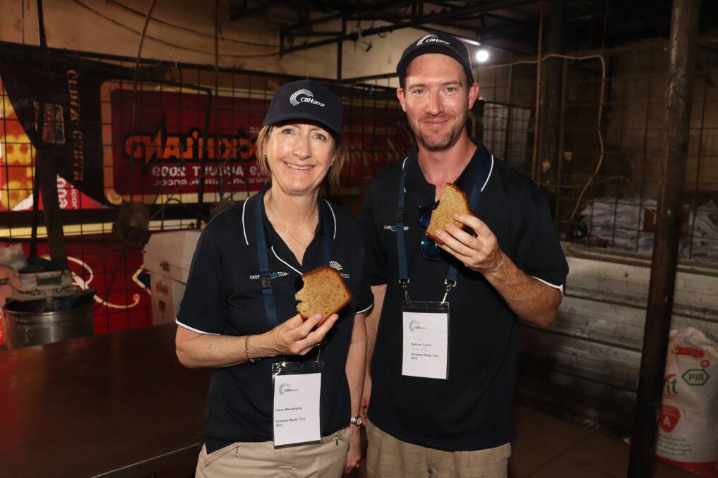 CBH board director Helen Woodhams with Bindi Bindi grower Nathan Turner eating a piece of banana cake made at Dyan's bakery. It was light and fluffy, with many growers managing to finish a whole piece even after a massive lunch with customers.