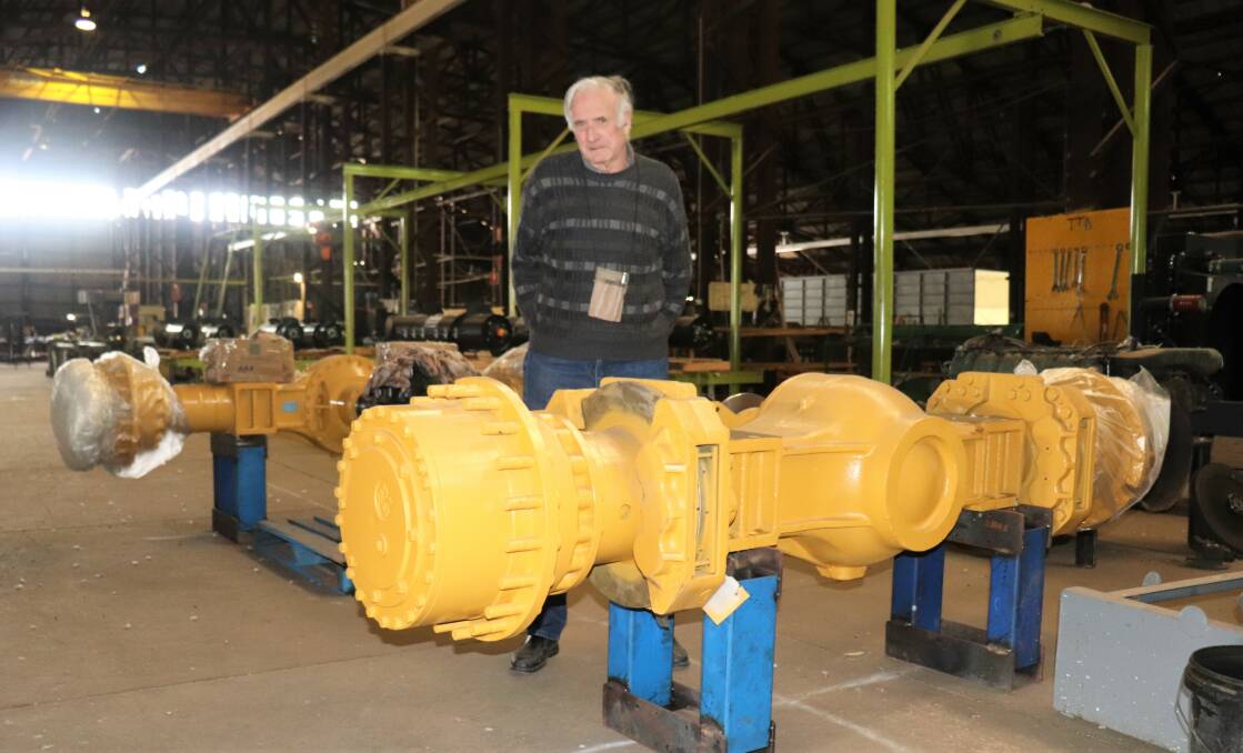Designer, engineer and manufacturer Laurie Phillips with the front and rear axle housings he hopes to use in version three of his Phillips Acremaster four-wheel-drive, articulated, high-horsepower tractor relying on simple mechanicals rather than complex electronics.
