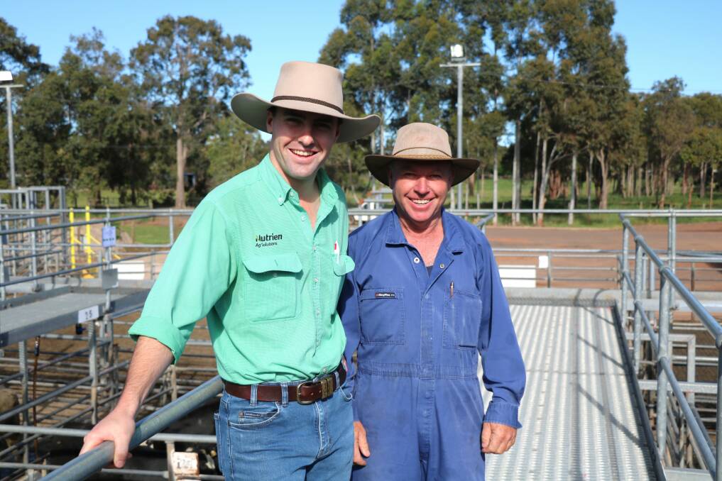 Auctioneer Austin Gerhardy (left), Nutrien Livestock, Manjimup, on the rail before the sale with local Kirup carrier Chris Wringe.
