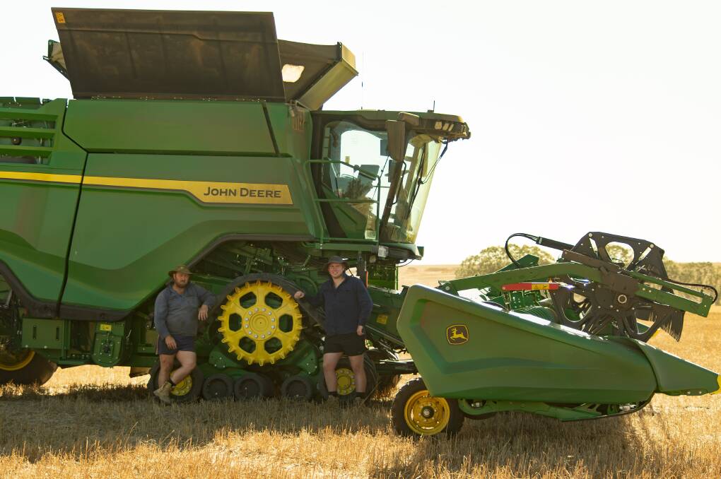 Mr Winter (left) and son Jack were impressed by the phenomenal numbers the John Deere X9 1100 Combine Harvester delivered.
