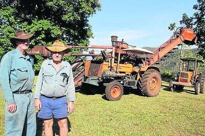 John and Jim Dockery with the Don-Mizzi cane harvester built in 1967 and still in use.