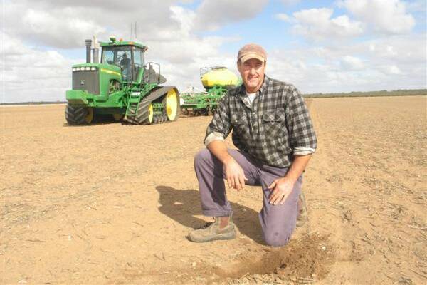 MUNTADGIN farmer Jeff Hooper is still smiling despite the lack of rain.  This picture was taken in May during a seeding program, but many farms throughout the Eastern Wheatbelt are as bare as this now with seed dormant in dry conditions.  "Yeah it's tough but we got between 6.5 and 7mm throughout our farm two weeks ago and that germinated the last of our crop," Mr Hooper said. 
