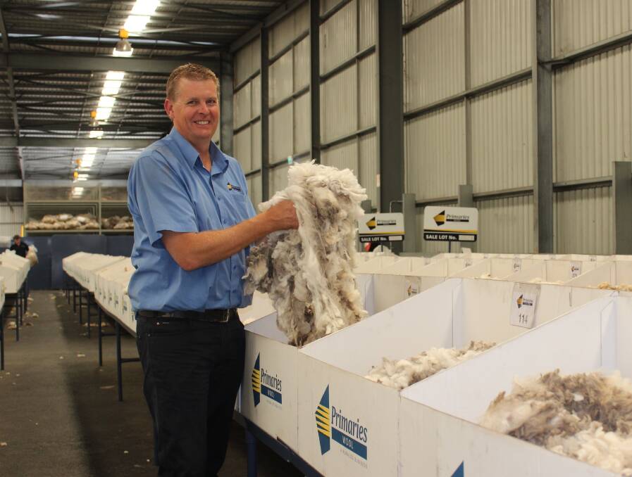 Primaries wool broker Stephen Squire on the show floor with some of the Evans family's wool that sold for a clip average of 1001 cents per kilogram last week.