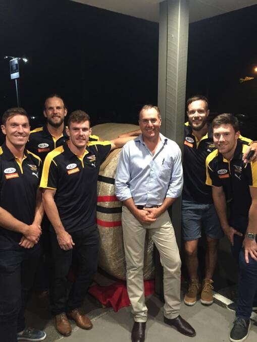 Co-organiser Richard Pollock (centre), Pollock Bray Agencies, Waroona, with West Coast Eagles players Sam Butler (left), Will Schofield, Luke Schuey, Mitchell Brown and Jeromy McGovern, and the world record $30,000 hay bale that sold at a fundraising event for the South West bushfires at Harvey on Friday night.