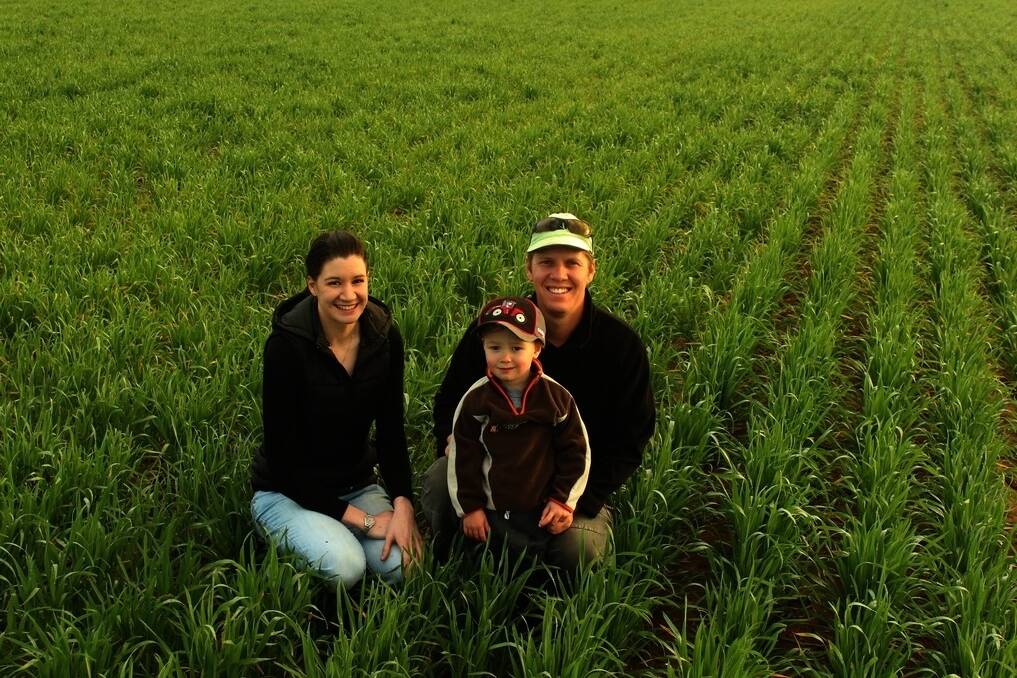 Sarah Perrett (left) with local grower Ben Strickland and son Joshua. Ms Perrett &#39;adopted an acre&#39;from Mr Strickland for the 2014 season, with this year&#39;s Scepter wheat going strong. 