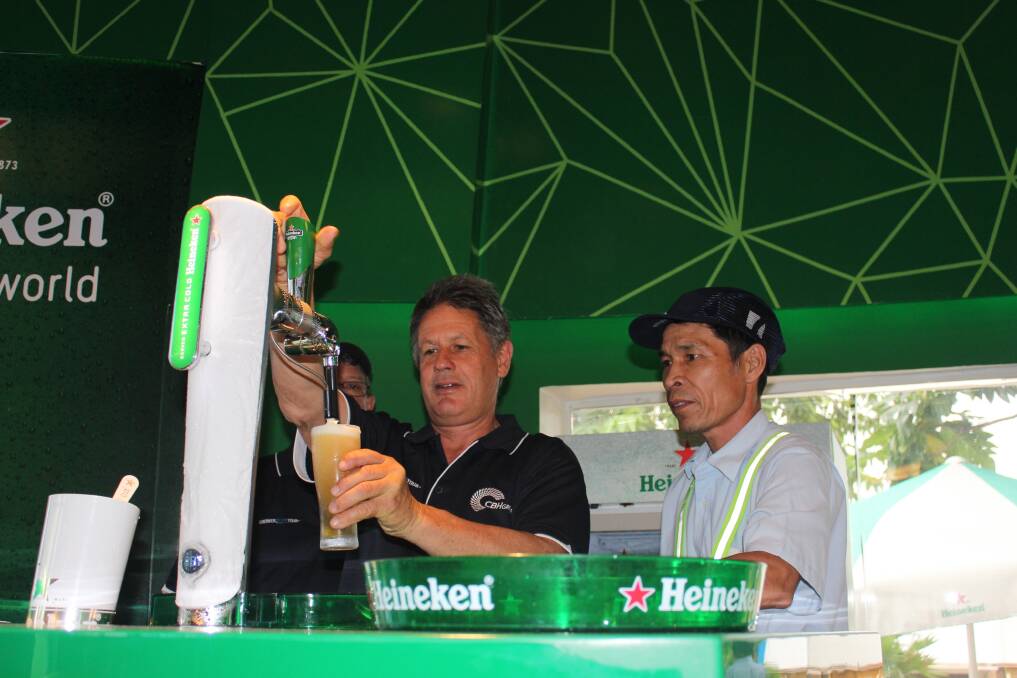 Kellerberrin grain grower David Leake pours a beer at the Heineken Vietnam brewery hospitality room.