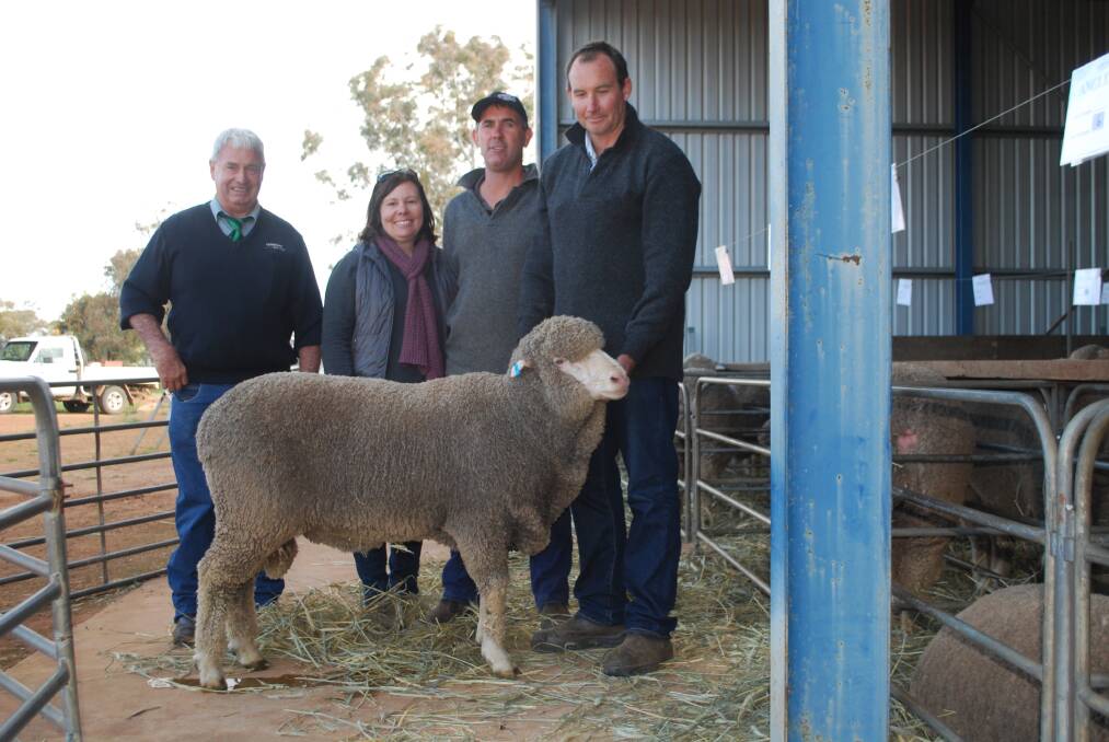 Landmark Gnowangerup agent Mike Moore (left), with buyers Michelle and Warren Dolan, Nyabing and Nick Crichton, Anglesey stud, holding the $2600 top price ram at the stud's sale at Gnowangerup.