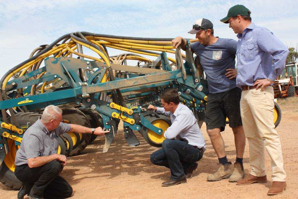AFGRI Dalwallinu ag sales manager Ray Trinder (left) discusses the independent tine breakout of the South African-made Equalizer Min-Till tine seeder with Equalizer product specialist and engineer Bert Badenhorst (kneeling), Dalwallinu farmer Brad McIlroy, who has purchased a model and AFGRI Dalwallinu branch manager Max Kerkmans.