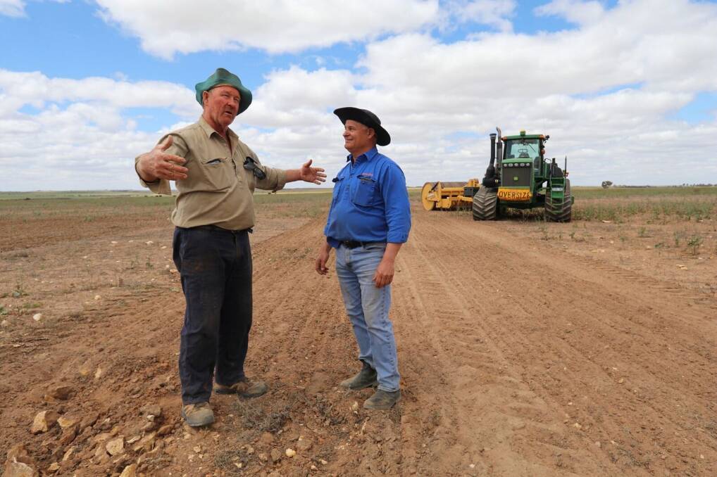 Ballidu farmer Phil Mincherton (left) and Rocks Gone founder Tim Pannell discuss the size of the rocks the Reefinator crushed into pea gravel, turning rocky outcrops into a seed bed. Mr Mincherton has seen a 1.1-2.6 tonnes a hectare wheat yield increase and a 2.3t/ha increase in barley yields. Photo: Lauren Calvin.