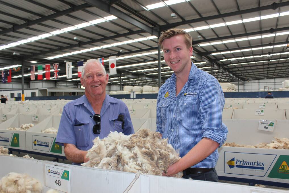 Three Springs woolgrower Anthony Thomas (left), who shears every six months and Primaries of WA's Lachlan Watts inspecting samples on the show floor.