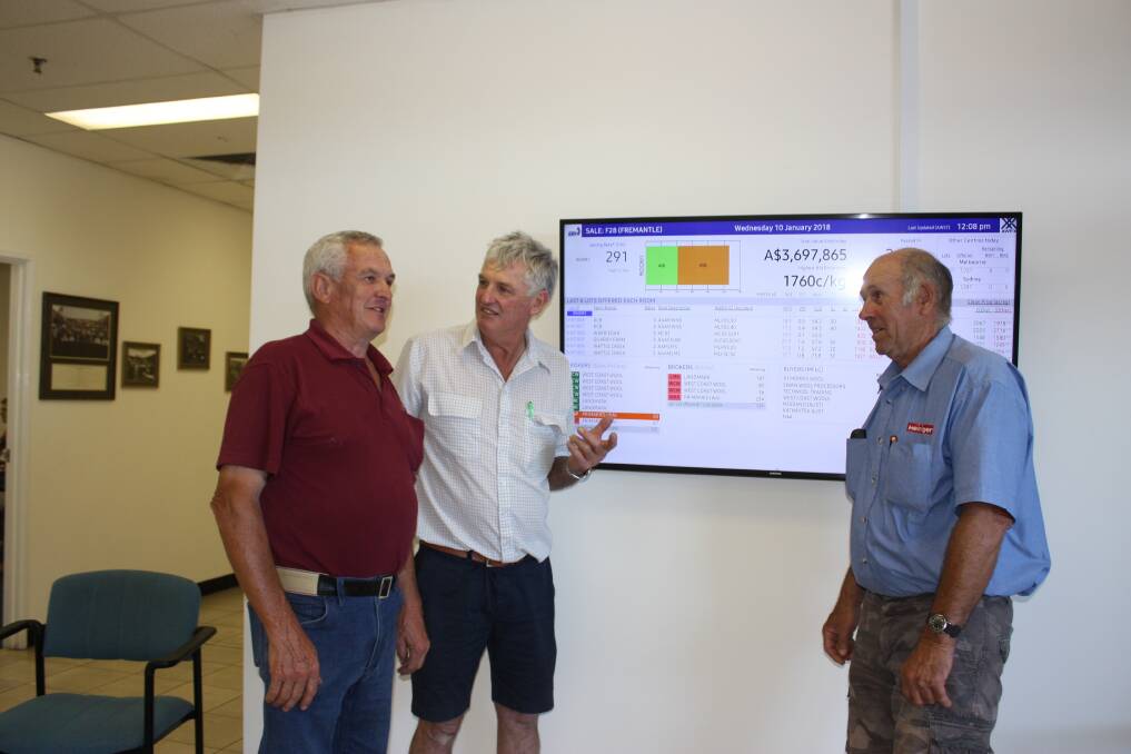  Blade shearing specialist, Australian Shearers' Hall of Fame inductee, superfine wool grower and The Grange Superfine Poll Merino stud principal Ron Niven (left), Manjimup, Wandering woolgrower and former WoolProducers Australia director Max Watts and former shearer turned woolgrower Len Simmons, West Brookton, are happy with what they see on the electronic display early on the first trading day 