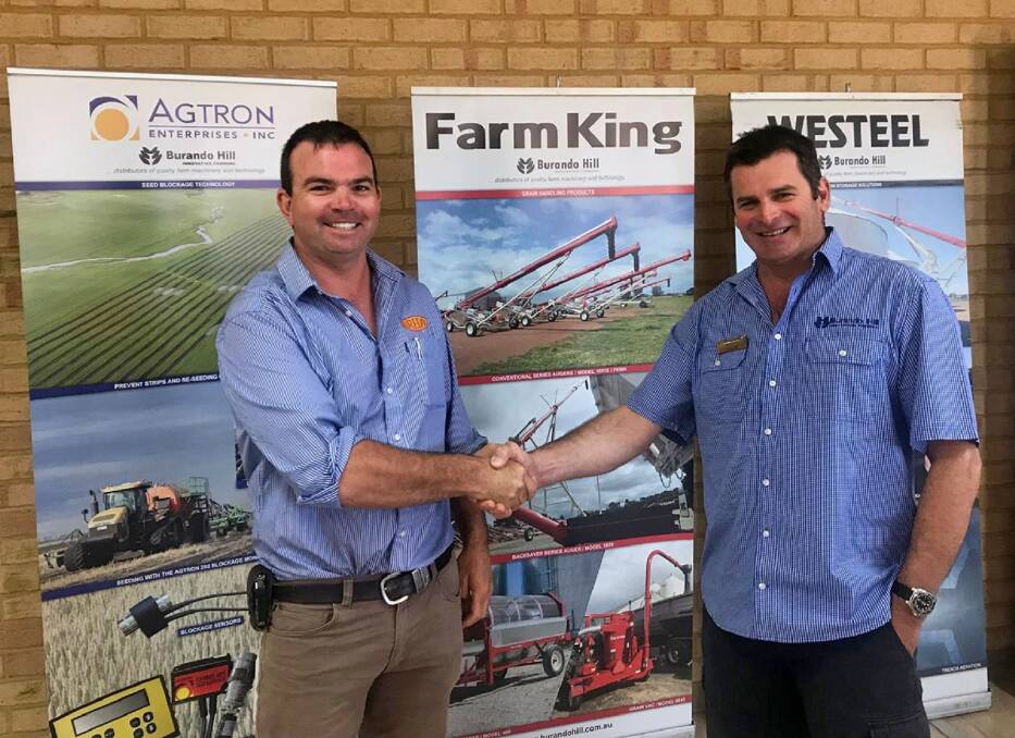 Australian distributor of Bredal spreaders Ben Nichols (left) with Burando Hill director Simon Hill last week completing details of an agreement between Bredal Australia and Burando Hill which sees Burando Hill become WA distributors of the Bredal range. See story.