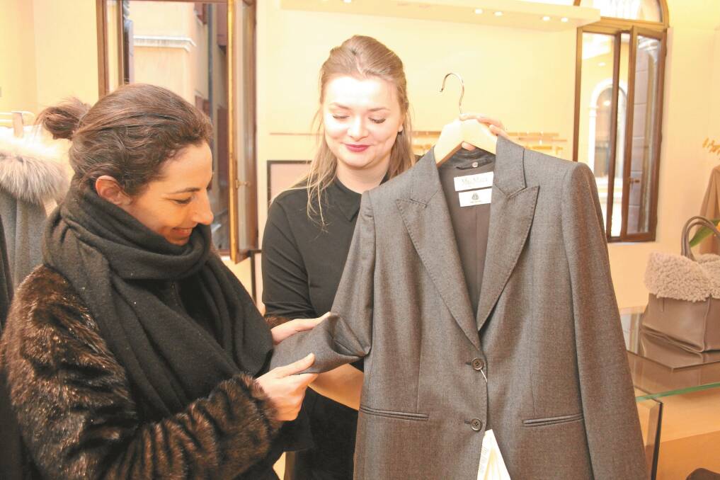The Woolmark Company's Milan-based marketing communications manager Francesca Ginnasi (left), takes a closer look at this ladies wool denim suit from a recent Max Mara range.