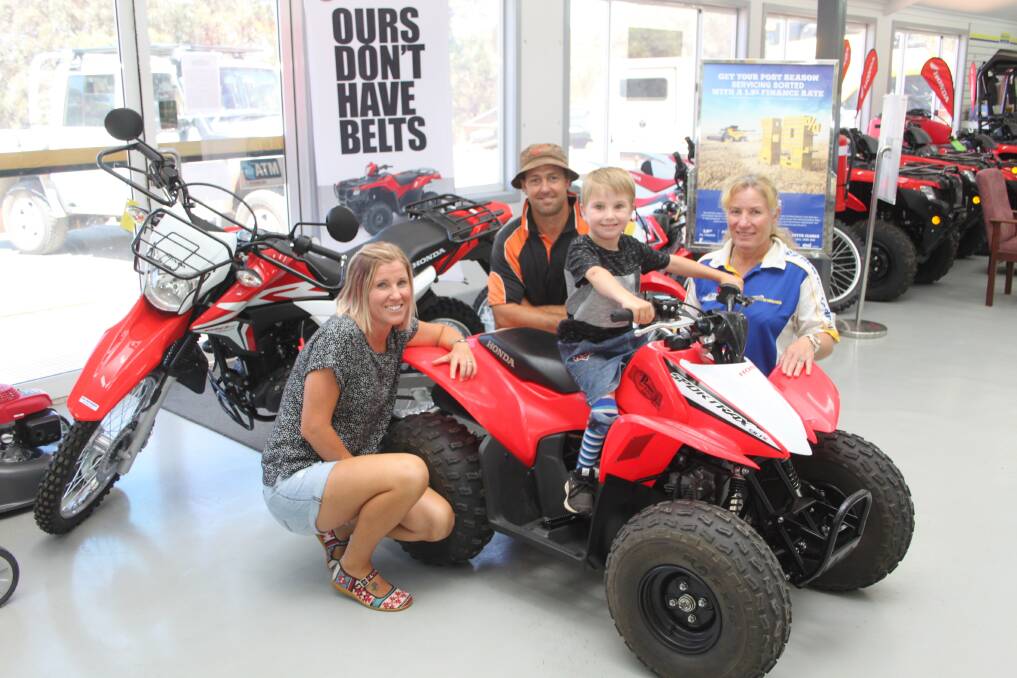 Narrogin farmers Donna (left) and Tom Penny with Vanessa Perkins, Perkins Machinery Narrogin and their son Oke Penny on his Honda 4-wheel motorbike donated by Tom Bowen Legacy Trust Fund and Perkins Machinery Narrogin and modified in the machinery dealership's workshop.