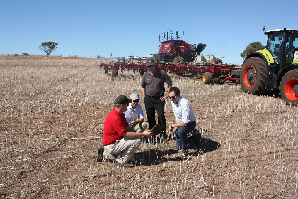 Vaderstad Industries international business manager Chris Bettschen (left), CLAAS Harvest Centre, Northam, salesman Murray Jones, Seed Hawk product specialist Russell McCagh and CLAAS Harvest Centre, Northam, branch manager James Moss, discussing the wireless network associated with the Seed Hawk rig during preparations for demonstrations days throughout the Wheatbelt.