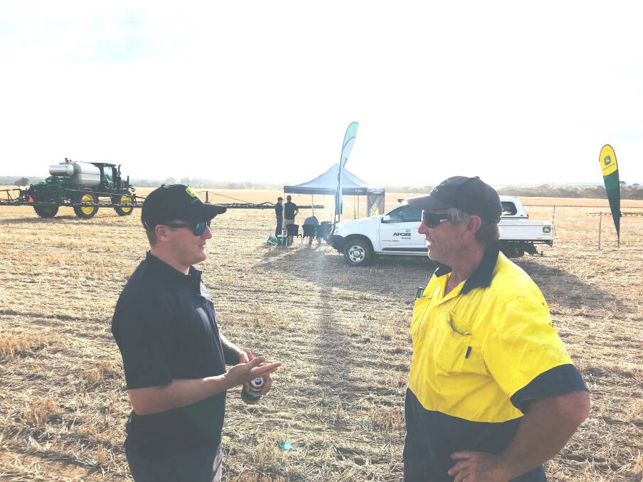 AFGRI Equipment, Albany, salesman Jack Lusty (left) and Mal Thomson, South Stirlings, discuss the new John Deere R4045 SP model, at the recent Stirlings to South Coast Farmers’ Ride and Drive Spray Day. 