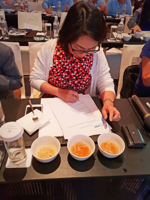 A delegate evaluating the eating quality and colour of yellow alkaline noodles made with Australian wheat at the Australian Wheat Seminar in Taipei, Taiwan.