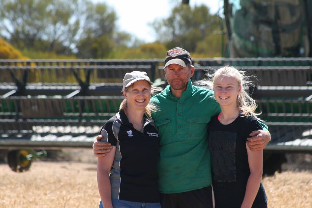 p Rachel Kirby (left) with her husband Ty and daughter Anastasia on their farm at Beacon last harvest. They have enjoyed a better start to the growing season in 2018.
