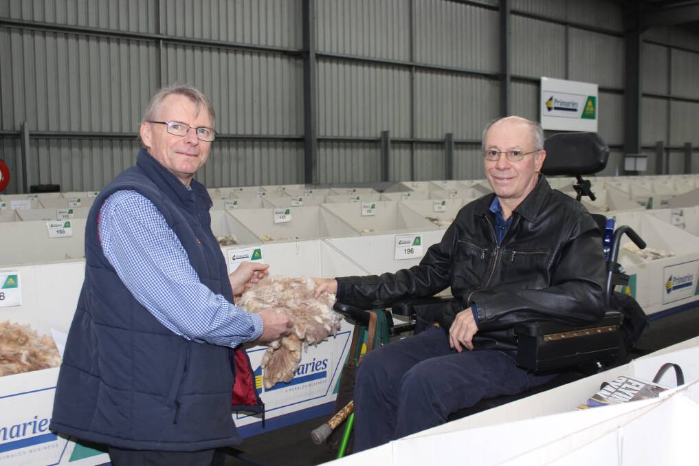 Primaries wool marketing representative Carl Poingdestre (left) stepped in for Peter Onions to show Peter Bligh formerly of Bligh Lee Farms, Mingenew, his final wool clip at the Primaries wool stores before it was sold two weeks ago.
