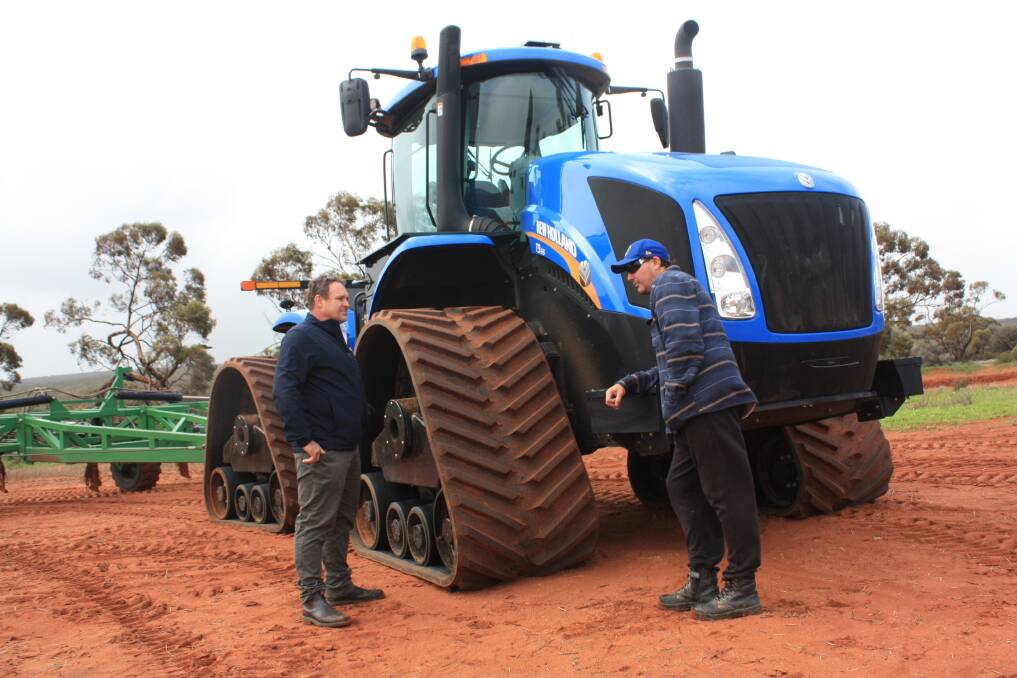 New Holland WA sales manager Geoff Anderson (left), takes Yuna farmer Jeff 'Charlie' Williamson on a walk-around of the new T9.615 New Holland tractor shoed with SmartTrax II tracks, before a test drive earlier this month.