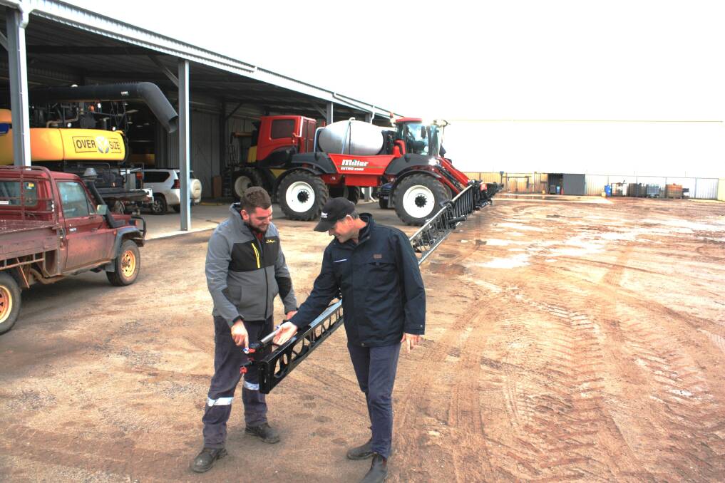  McIntosh & Son mechanic Steve Rowland (left) and McIntosh Distribution's Mike Symes discuss the performance of the Raven Hawkeye Nozzle Control System fitted to this Miller Nitro 6365 self-propelled boomsprayer that was delivered to a Morawa farmer.