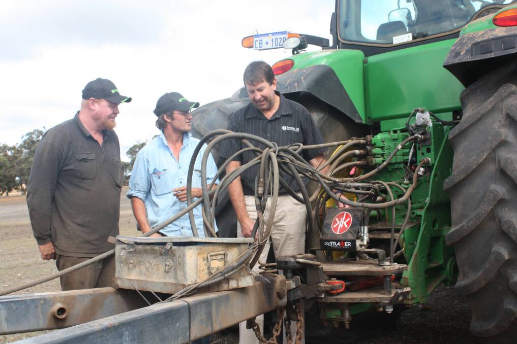 Cranbrook farmer Theo Cunningham (left) and Burando Hill salesman Michael Kowald discuss the hydraulic set-up on the ProTrakker guidance system, which is growing in popularity in WA to enable accurate sowing into the previous year's row without disturbing stubble.