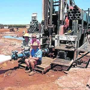 Steve Chitty (left), from Western Drilling and Pardoo station owner Graeme Rogers (right), watching the bore dispense water at 200 litres per second.