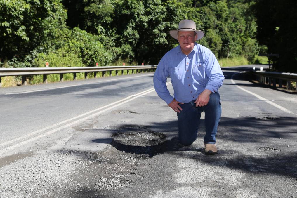 Hill MP Shane Knuth inspecting potholes on the Palmerston Highway near Gooligan Creek picnic area.