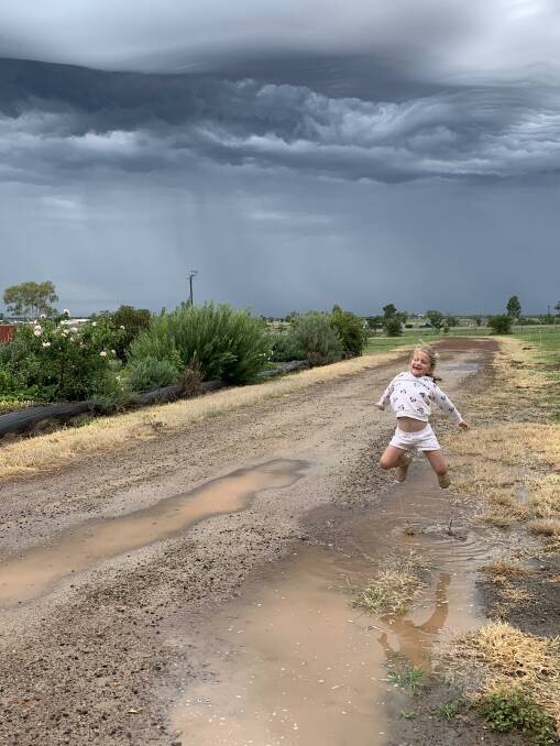 JUMPING FOR JOY: Sammy Nixon, 6, who was born in dry times, is enjoying the rain on her property west of Roma. Photo: Rachel Nixon.