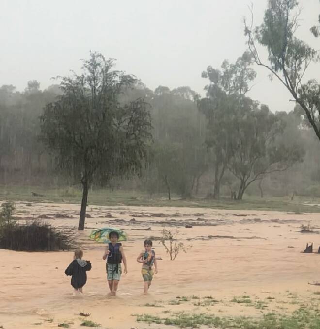 Pippa Hewitt 2, plays with brothers Harry Hewitt 7 and Hugo Hewitt 5 on Hanging Rock Station at Belyando Crossing after the biggest deluge of their lifetimes.