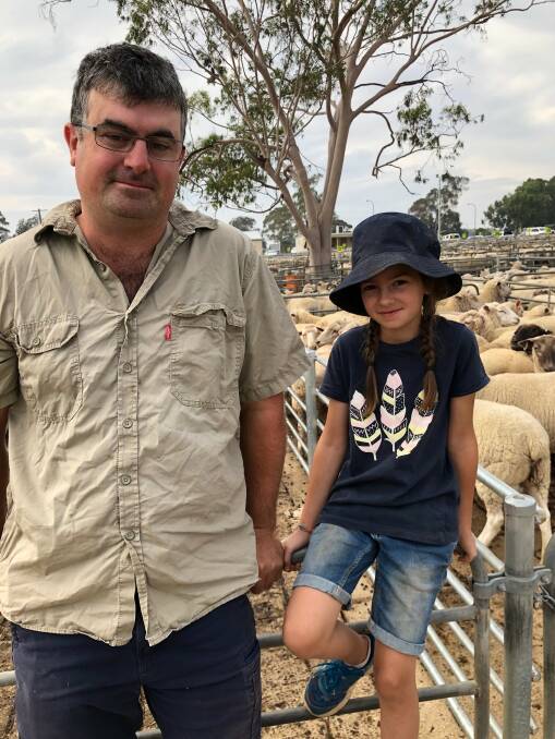 ENTIRE DROP: Jonathon Perry, Balldale, NSW, with his niece Leah Perry, who sold her entire drop of lambs for $165 at Corowa, NSW.